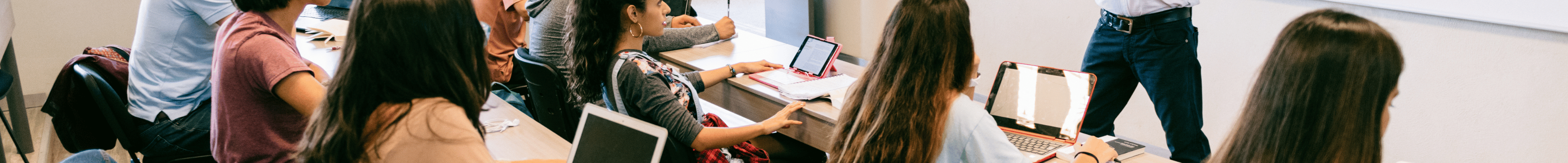 students in classroom taking notes