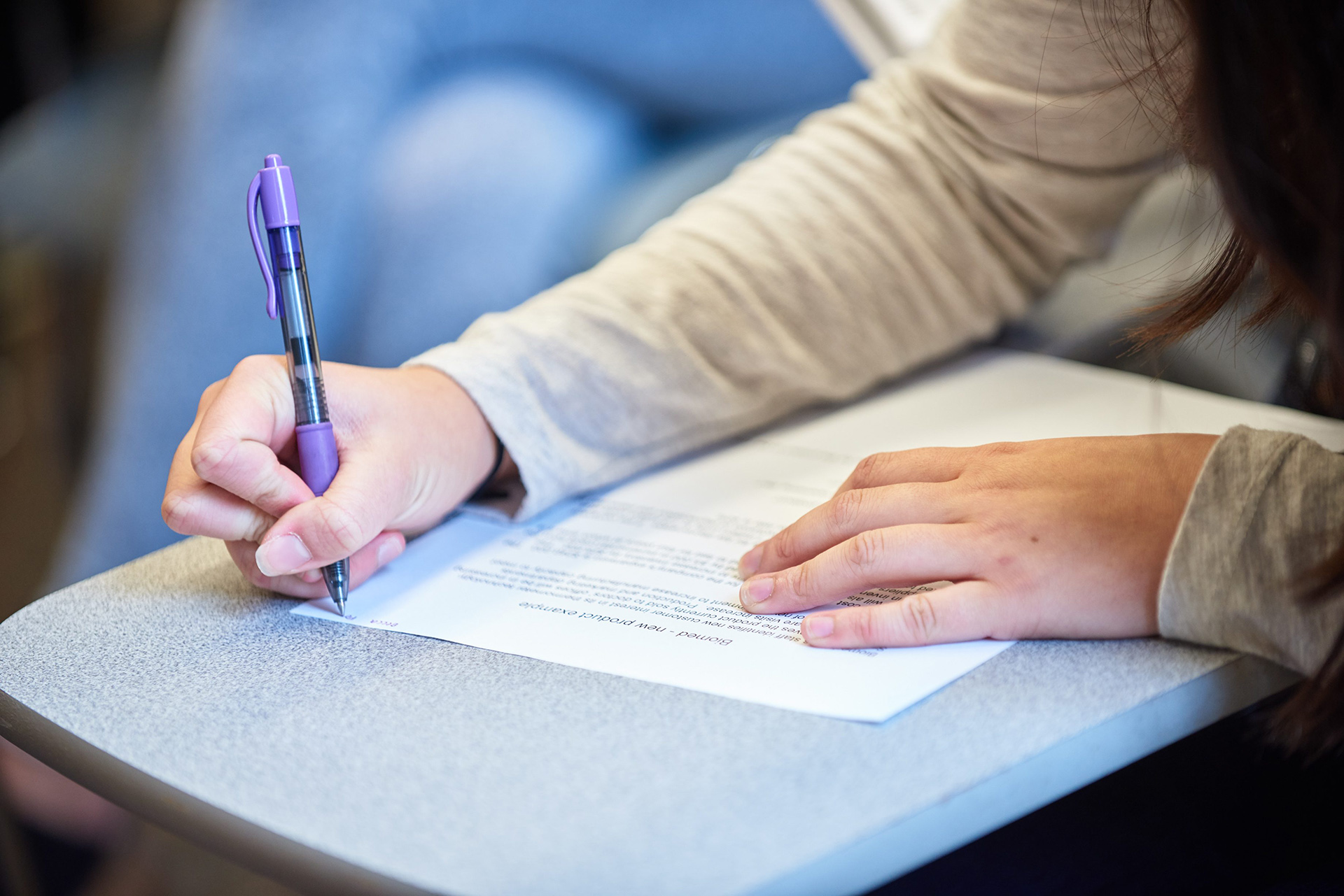 Student writing on an exam